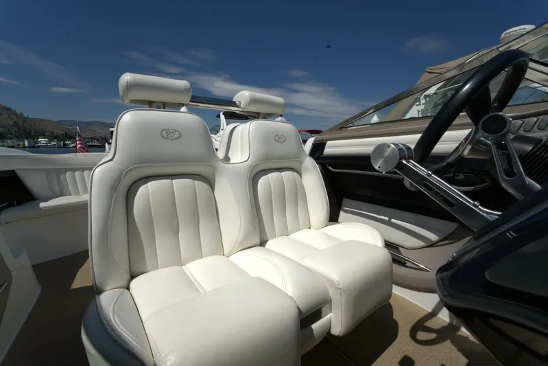  Yacht Photos Pics 2005 Cobalt 343 boat interior with white leather seats and steering wheel.