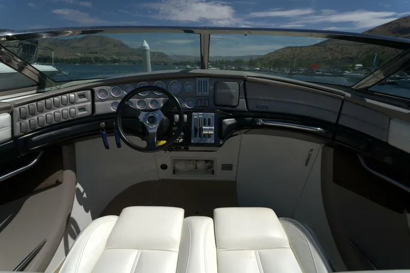  Yacht Photos Pics Interior of a 2005 Cobalt 343 boat cockpit with steering wheel and gauges.