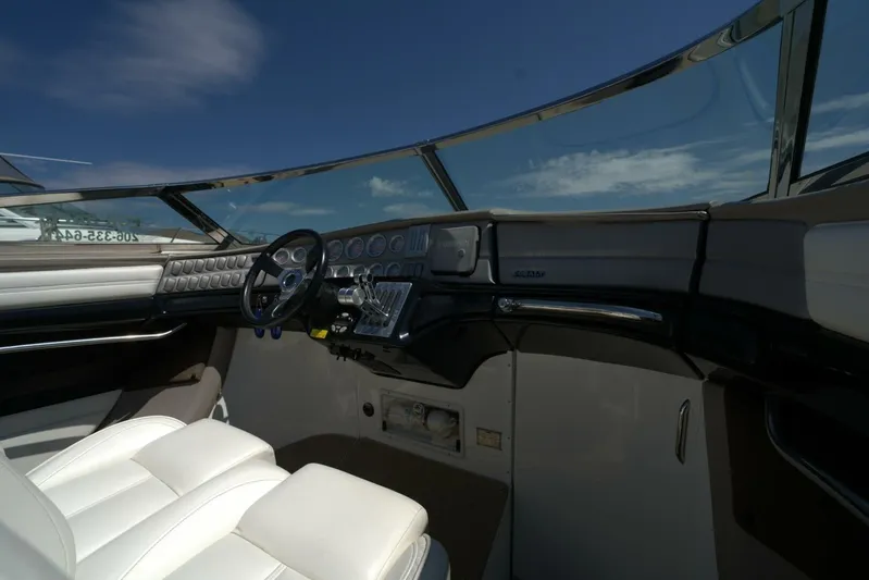  Yacht Photos Pics Interior of a 2005 Cobalt 343 boat cockpit with steering wheel and gauges.