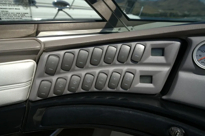  Yacht Photos Pics Dashboard controls of a 2005 Cobalt 343 boat, featuring multiple switches and a gauge.