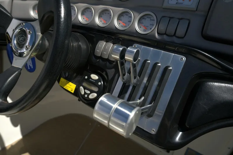  Yacht Photos Pics Steering wheel and controls of a 2005 Cobalt 343 boat cockpit.