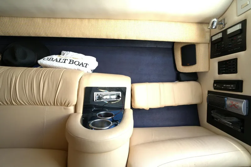  Yacht Photos Pics Interior of a 2005 Cobalt 343 boat with beige leather seating and audio controls.