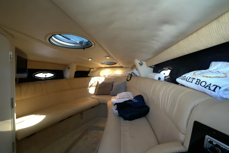  Yacht Photos Pics Luxurious interior of a 2005 Cobalt 343 boat with beige seating and portholes.