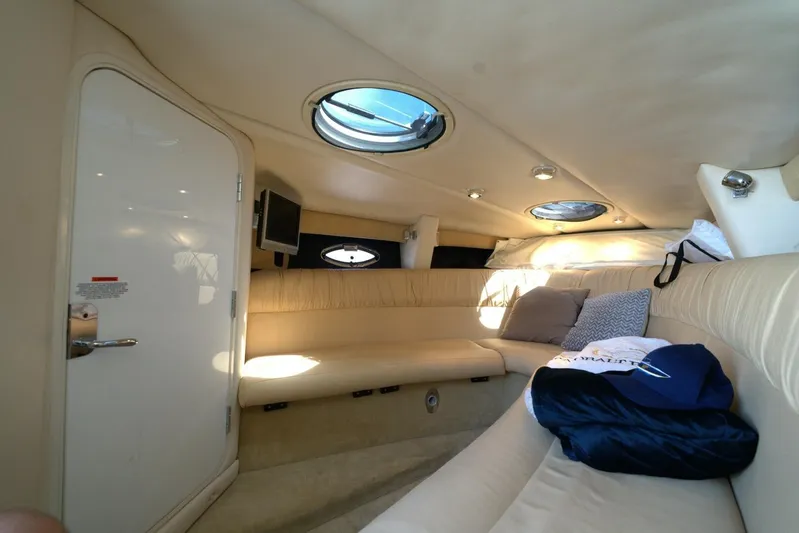  Yacht Photos Pics Interior of 2005 Cobalt 343 boat with beige seating and porthole windows.