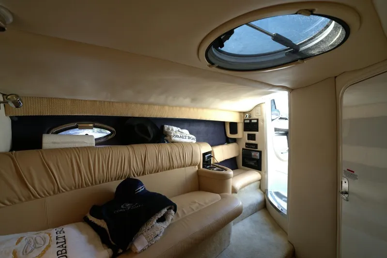  Yacht Photos Pics Luxurious interior of a 2005 Cobalt 343 boat with beige leather seating and skylight.