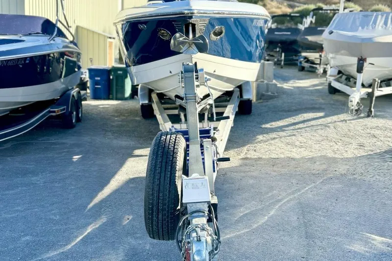  Yacht Photos Pics 2005 Cobalt 343 boat on trailer, parked outdoors, surrounded by other boats.