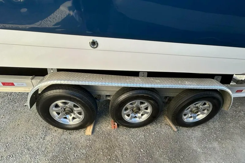  Yacht Photos Pics Triple-axle trailer with Cobalt 343 boat, 2005 model, on gravel surface.