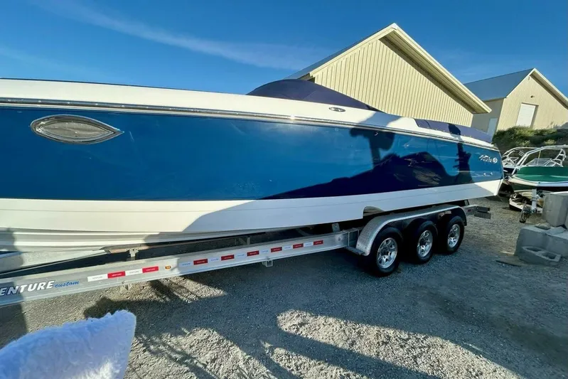  Yacht Photos Pics 2005 Cobalt 343 boat on trailer, blue and white, parked outdoors.