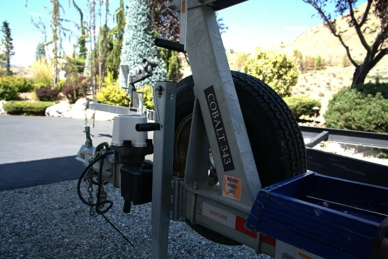  Yacht Photos Pics Trailer hitch of a 2005 Cobalt 343 with spare tire, parked on gravel driveway.
