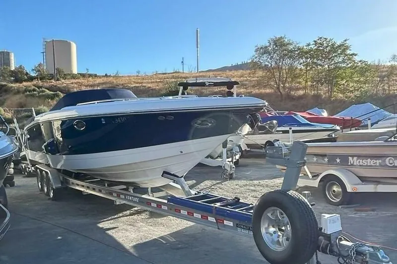  Yacht Photos Pics 2005 Cobalt 343 boat on trailer in outdoor storage area, surrounded by other boats.