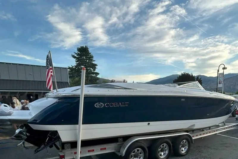  Yacht Photos Pics 2005 Cobalt 343 boat on trailer, American flag, scenic mountain backdrop.