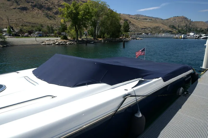  Yacht Photos Pics 2005 Cobalt 343 boat docked with cover, American flag, scenic lake view.
