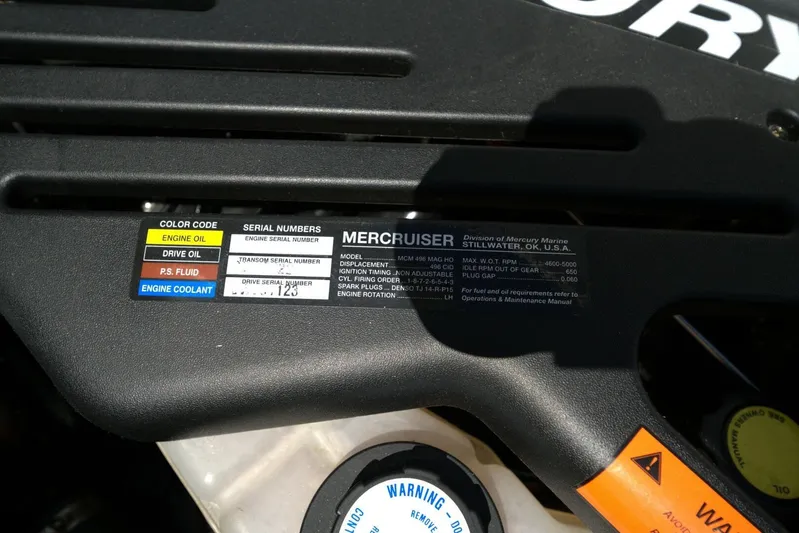  Yacht Photos Pics Label on MerCruiser engine cover, showing color codes and serial numbers for maintenance.