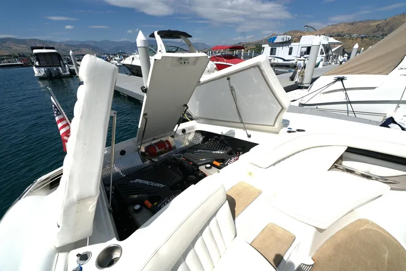  Yacht Photos Pics 2005 Cobalt 343 boat with open engine compartment at marina, showcasing Mercury engines.