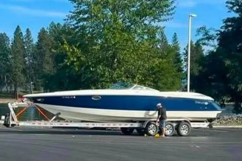  Yacht Photos Pics 2005 Cobalt 343 boat on trailer, parked outdoors with trees in the background.
