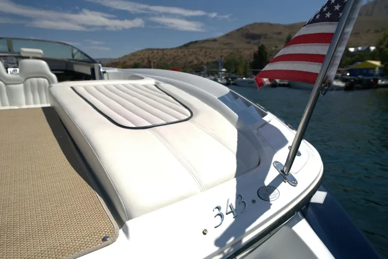  Yacht Photos Pics 2005 Cobalt 343 boat with American flag on a sunny day by the water.