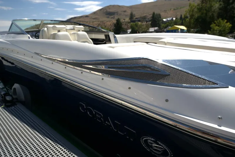  Yacht Photos Pics 2005 Cobalt 343 boat with sleek design, white seating, and scenic background.