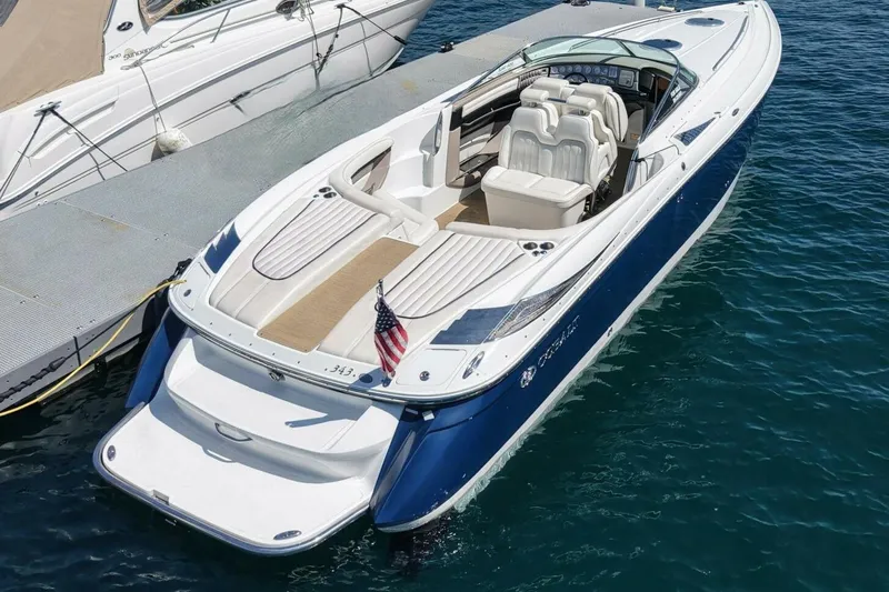  Yacht Photos Pics 2005 Cobalt 343 boat docked, featuring sleek design and American flag.