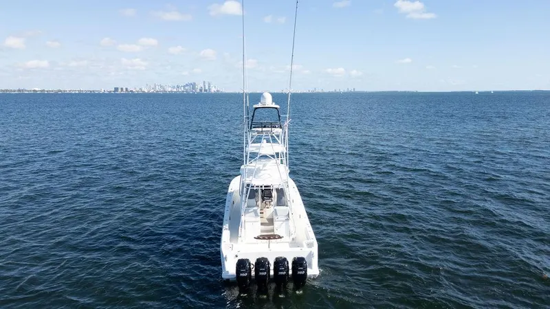  Yacht Photos Pics 2015 SeaVee 430 Fisharound boat on open water, distant city skyline.