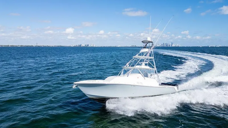  Yacht Photos Pics 2015 SeaVee 430 Fisharound cruising on open water under clear blue skies.