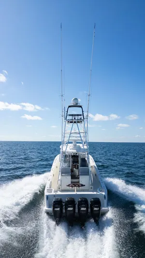  Yacht Photos Pics 2015 SeaVee 430 Fisharound cruising on open water under clear blue sky.