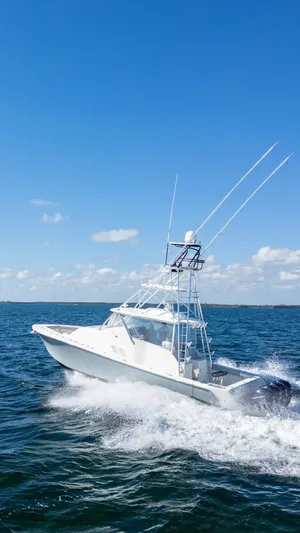  Yacht Photos Pics 2015 SeaVee 430 Fisharound cruising on open water under clear blue skies.
