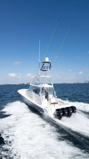  Yacht Photos Pics 2015 SeaVee 430 Fisharound boat cruising on open water under clear blue sky.