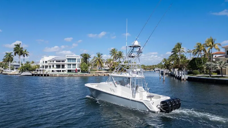  Yacht Photos Pics 2015 SeaVee 430 Fisharound boat cruising in a scenic waterfront area with palm trees.