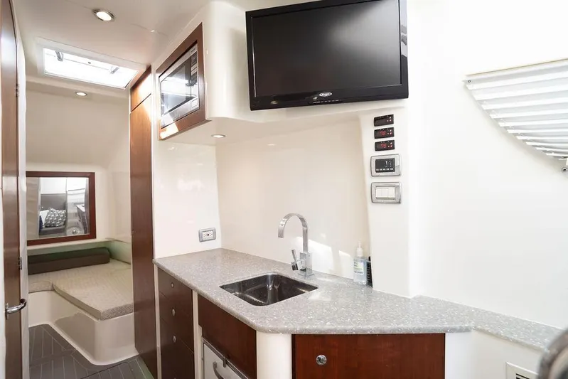  Yacht Photos Pics 2015 SeaVee 430 Fisharound interior with kitchenette, sink, and TV.