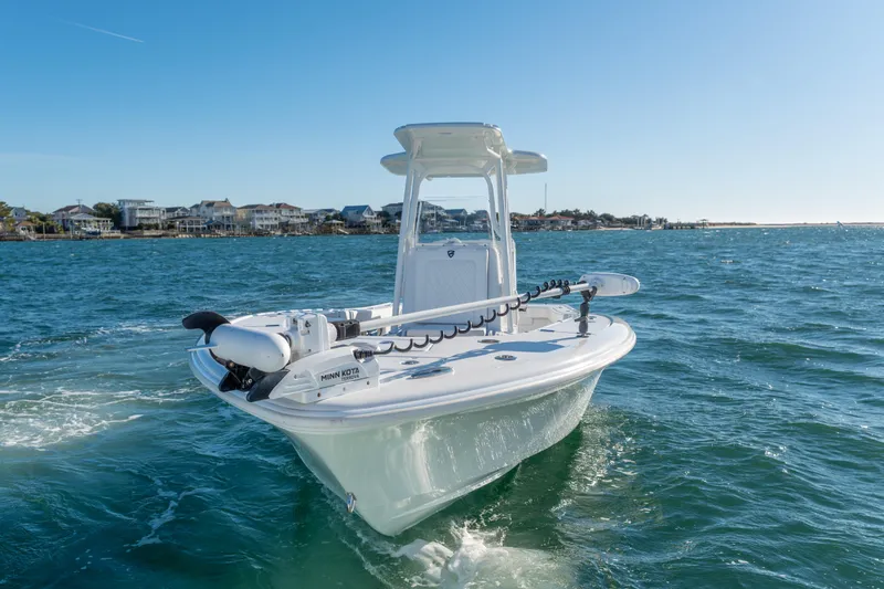  Yacht Photos Pics 2020 BARKER 26 boat cruising on a sunny day near coastal homes.