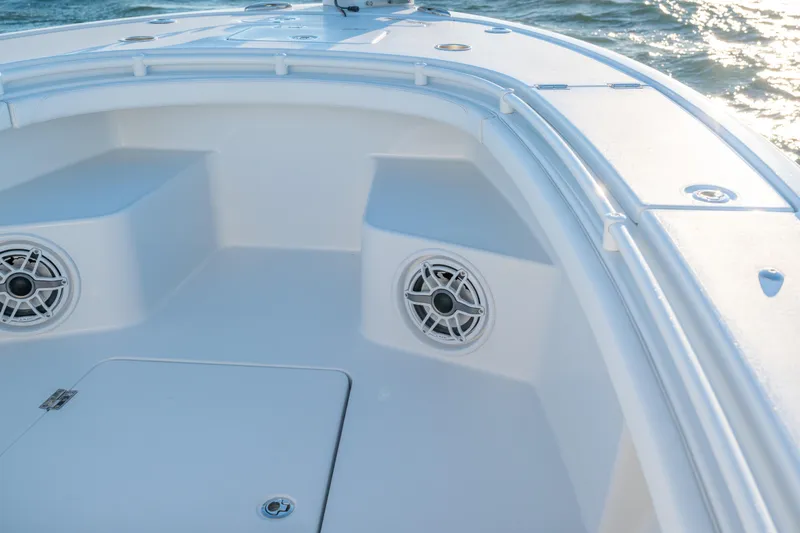  Yacht Photos Pics 2020 BARKER 26 boat interior with speakers, white seating, and ocean view.