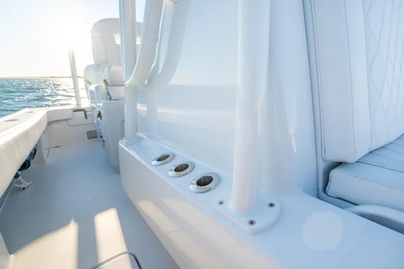  Yacht Photos Pics Interior view of a 2020 BARKER 26 boat with white seating and rod holders.