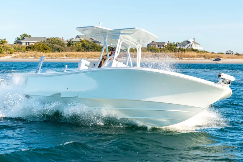  Yacht Photos Pics 2020 BARKER 26 boat cruising on water near a coastal landscape.