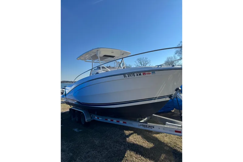 Jeanneau Leader 9.0 Cc Yacht Photos Pics 2019 Jeanneau Leader 9.0 CC boat on trailer under clear blue sky.