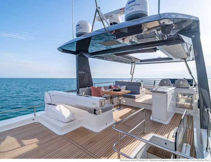  Yacht Photos Pics Luxurious 2025 Beneteau Grand Trawler 62 yacht deck with seating and ocean view.