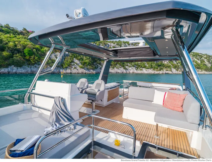  Yacht Photos Pics Luxurious 2025 Beneteau Grand Trawler 62 yacht with spacious deck and scenic water view.
