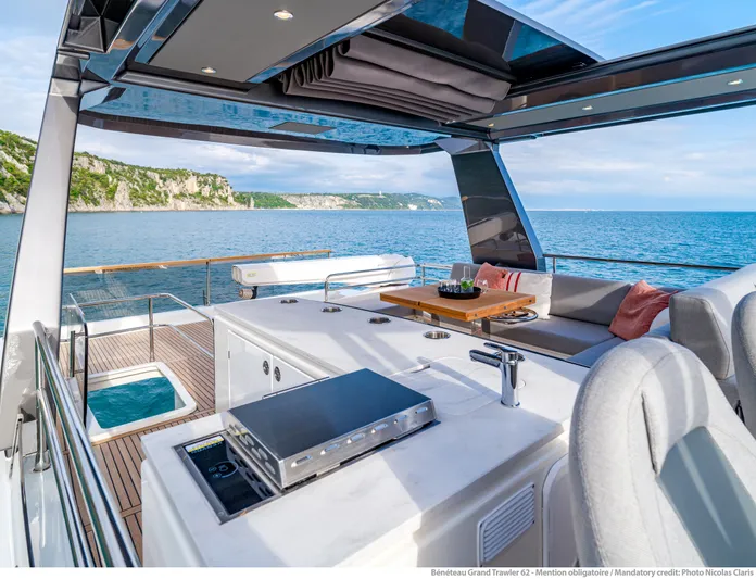  Yacht Photos Pics Luxurious 2025 Beneteau Grand Trawler 62 yacht with spacious deck and stunning ocean view.