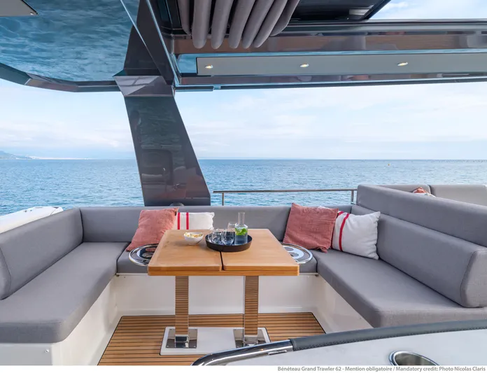  Yacht Photos Pics Luxurious seating area on 2025 Beneteau Grand Trawler 62 yacht with ocean view.