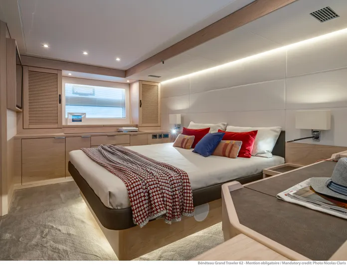  Yacht Photos Pics Luxurious bedroom interior of 2025 Beneteau Grand Trawler 62 yacht, featuring modern design and cozy decor.