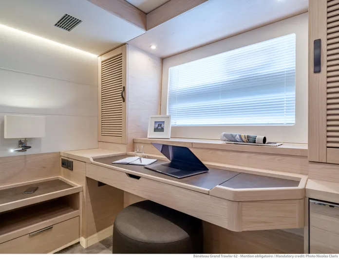  Yacht Photos Pics Interior of 2025 Beneteau Grand Trawler 62 with modern desk and window.