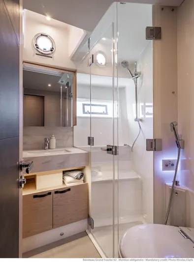  Yacht Photos Pics Luxurious bathroom in 2025 Beneteau Grand Trawler 62 yacht with modern fixtures.