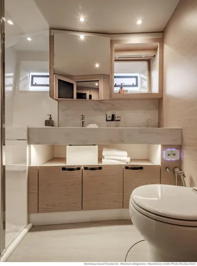  Yacht Photos Pics Luxurious bathroom in 2025 Beneteau Grand Trawler 62 yacht, featuring modern fixtures and elegant design.