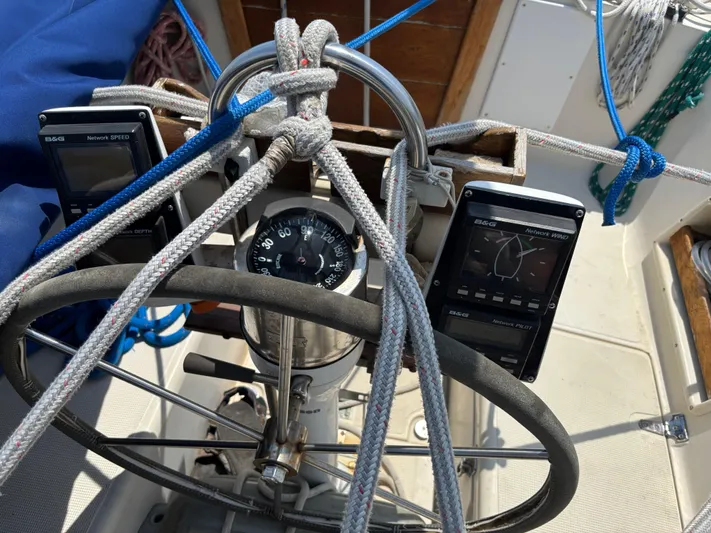 Pacific Seacraft Crealock 37 Yacht Photos Pics Steering wheel and navigation instruments on a 1995 Pacific Seacraft Crealock 37 sailboat.