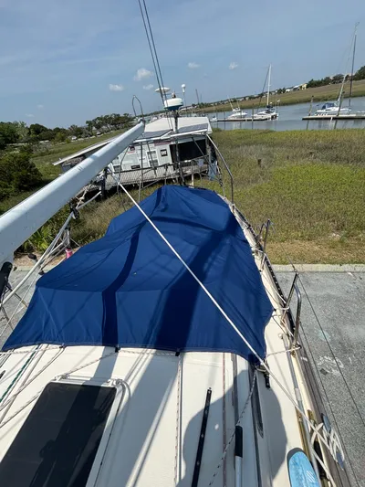 Pacific Seacraft Crealock 37 Yacht Photos Pics 1995 Pacific Seacraft Crealock 37 sailboat docked near a serene waterfront.