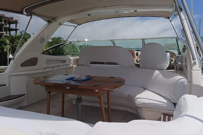2000 Sea Ray 460 Sundancer @ Ixtapa Yacht Photos Pics Interior view of a 2000 Sea Ray 460 Sundancer yacht with seating and table.