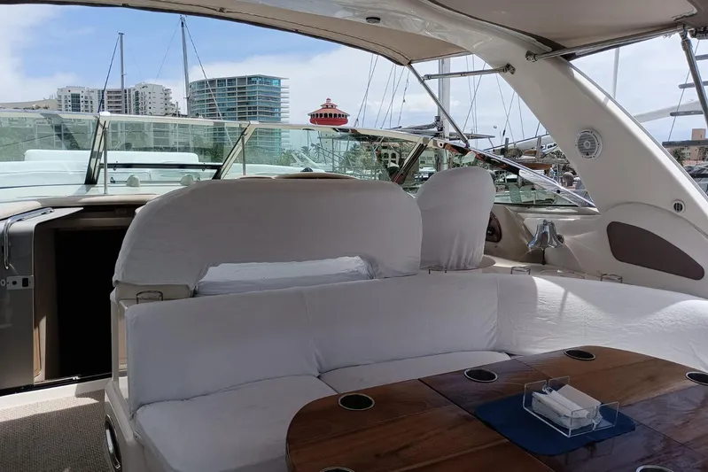 2000 Sea Ray 460 Sundancer @ Ixtapa Yacht Photos Pics Interior view of 2000 Sea Ray 460 Sundancer yacht with white seating and wooden table.