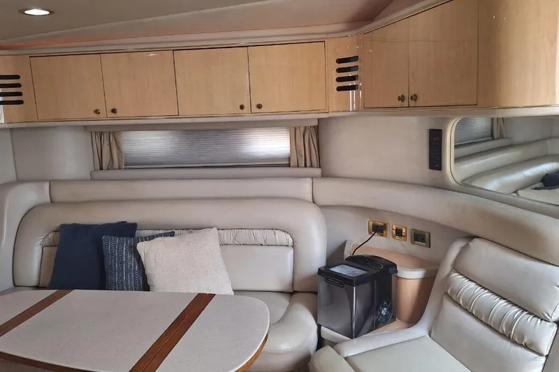2000 Sea Ray 460 Sundancer @ Ixtapa Yacht Photos Pics Luxurious interior of 2000 Sea Ray 460 Sundancer yacht with plush seating and cabinetry.