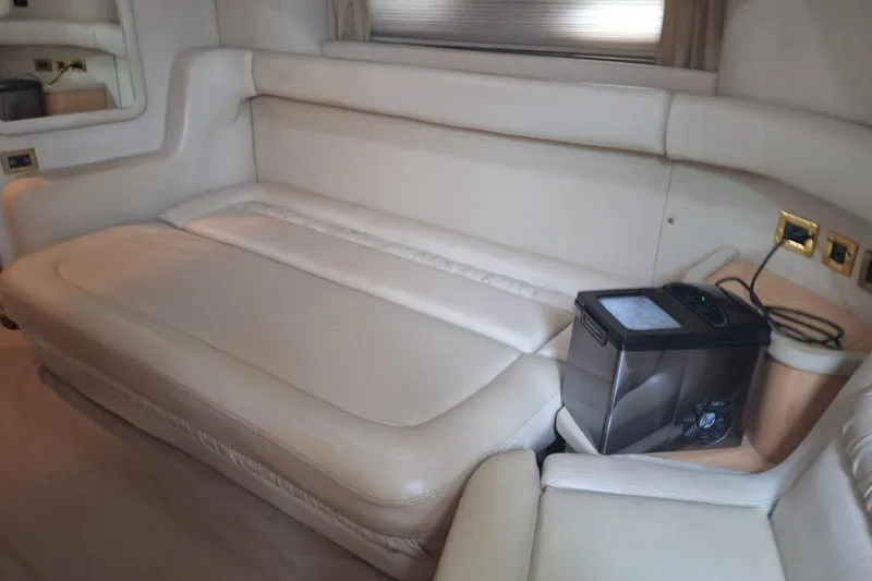 2000 Sea Ray 460 Sundancer @ Ixtapa Yacht Photos Pics Interior of 2000 Sea Ray 460 Sundancer with beige leather seating and small appliance.