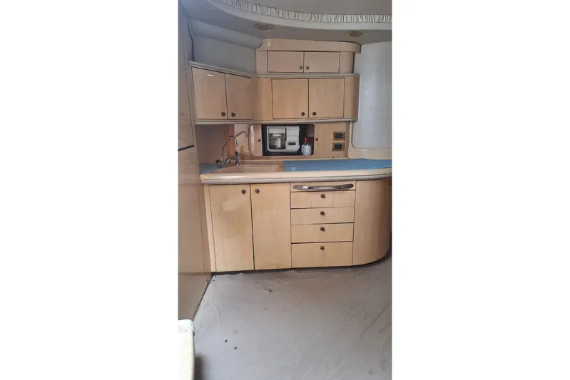 2000 Sea Ray 460 Sundancer @ Ixtapa Yacht Photos Pics 2000 Sea Ray 460 Sundancer yacht kitchen with wooden cabinets and modern appliances.