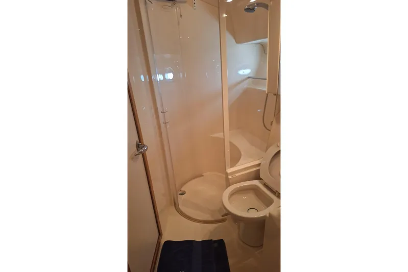 2000 Sea Ray 460 Sundancer @ Ixtapa Yacht Photos Pics Bathroom interior of 2000 Sea Ray 460 Sundancer yacht, featuring shower and toilet.
